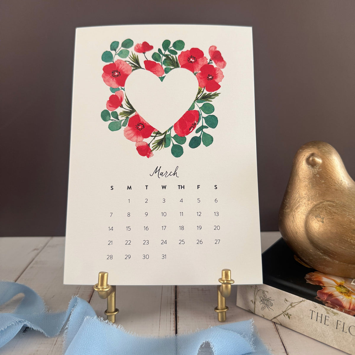 March page with a heart wreath of red poppies and soft green leaves