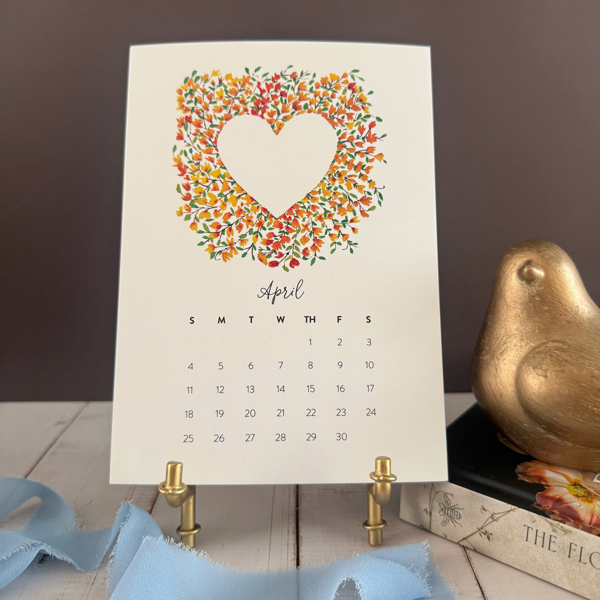 April page with a heart wreath of tiny gold and orange forsythia blossoms