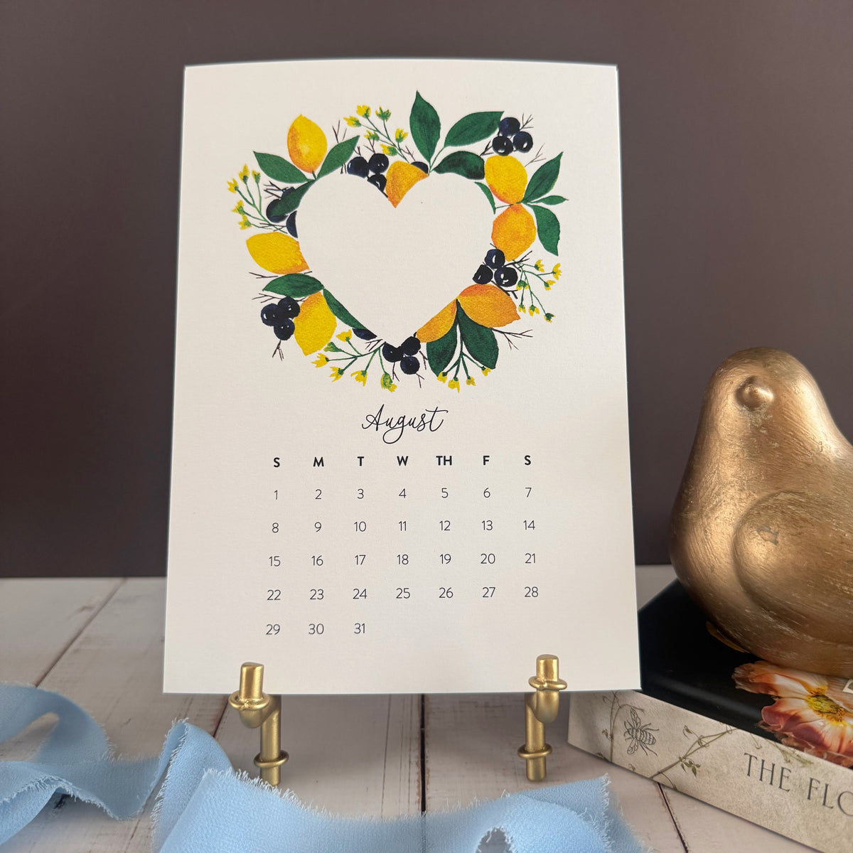 August page with a heart wreath of lemons, blueberries and deep green leaves
