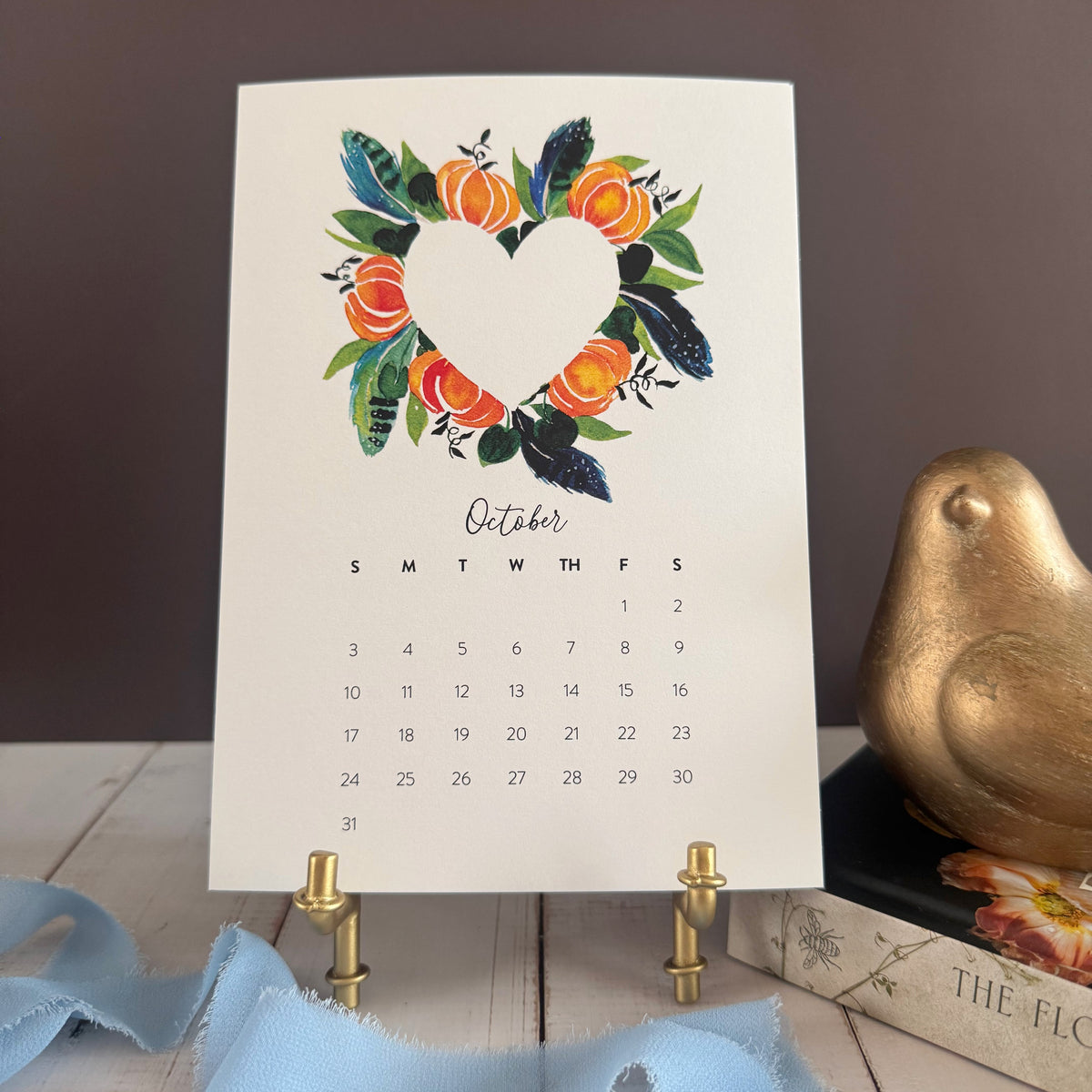 October page with a heart wreath of orange pumpkins, teal feathers, and leaves